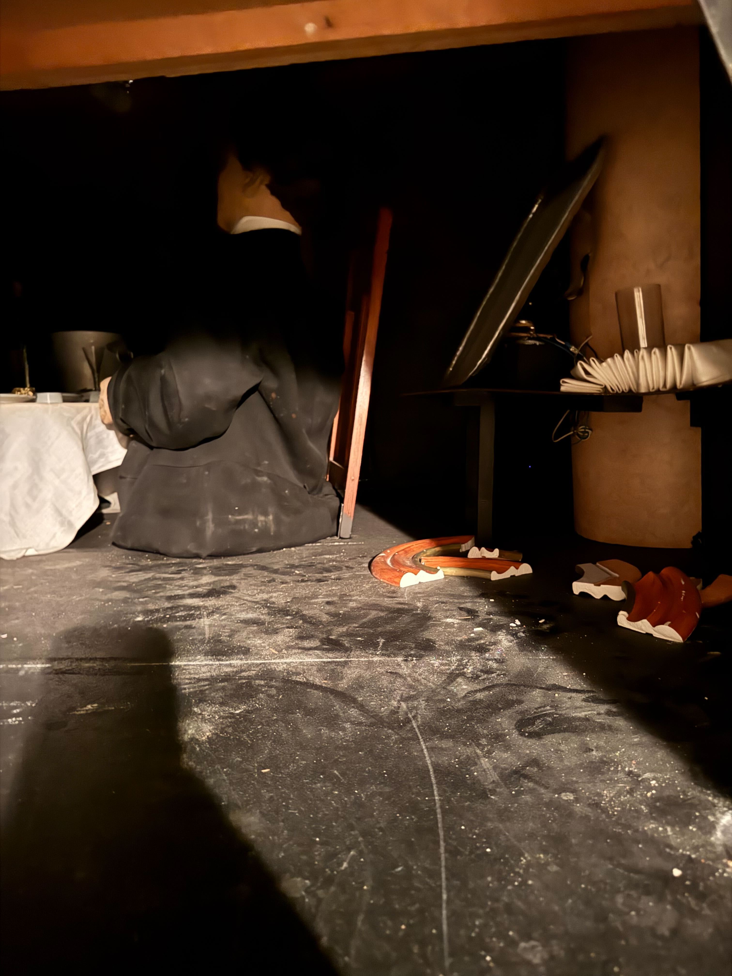 A dirty, dusty scene
with an old spy doll and a tray.